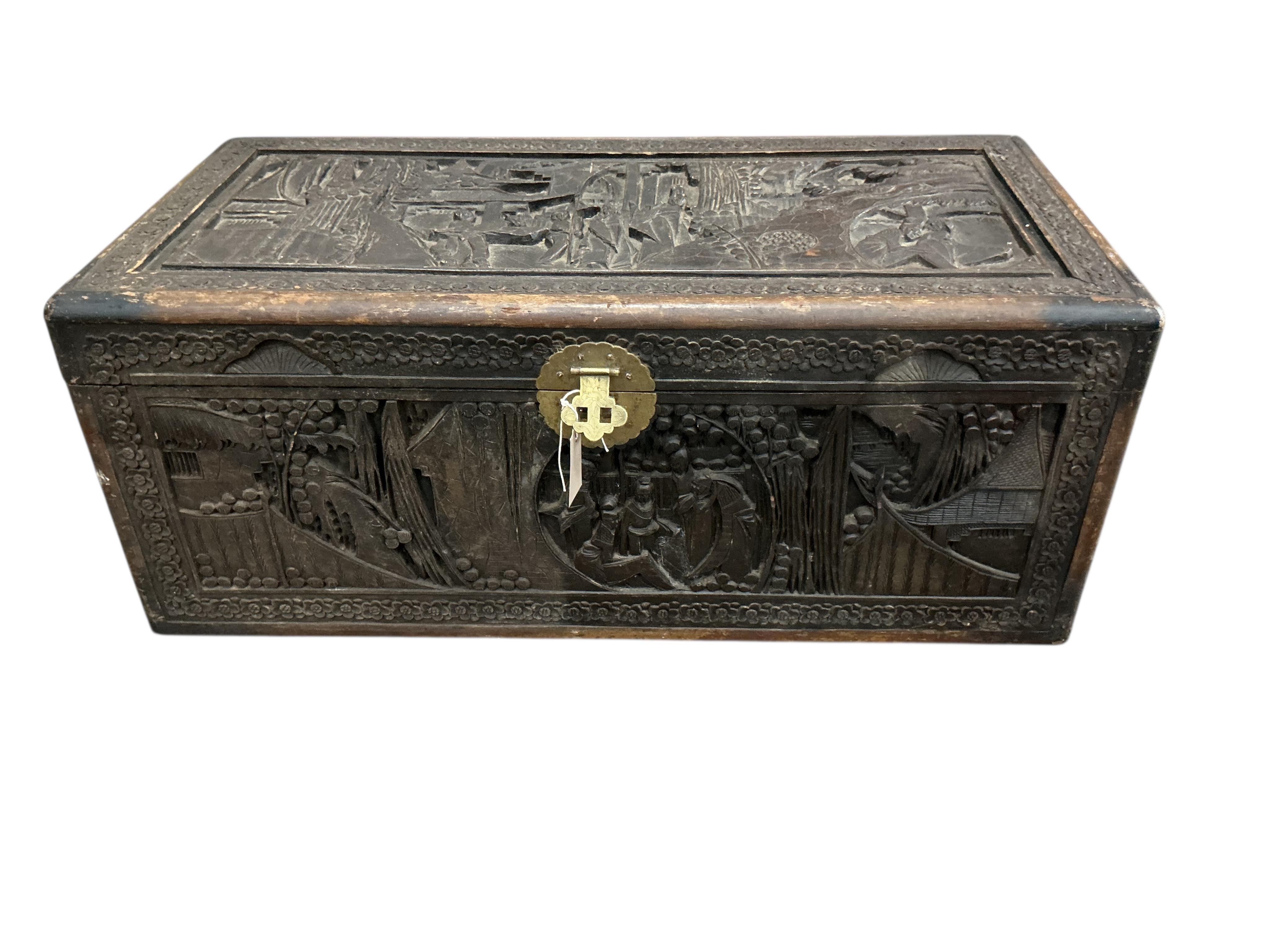 A Chinese carved camphor wood trunk, width 90cm, depth 44cm, height 36cm
